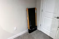 The LifePro TimberTrek Treadmill leaning on a wall by a door