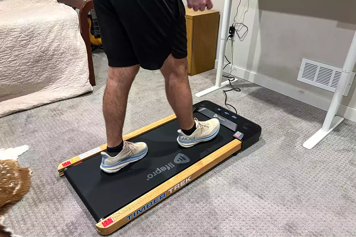 A person walking on the LifePro TimberTrek Treadmill