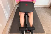 A person uses the Marcy MWM-989 150 lb Stack Weight Home Gym to exercise
