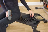 A person picking up a massager head for the RENPHO Power Massage Gun