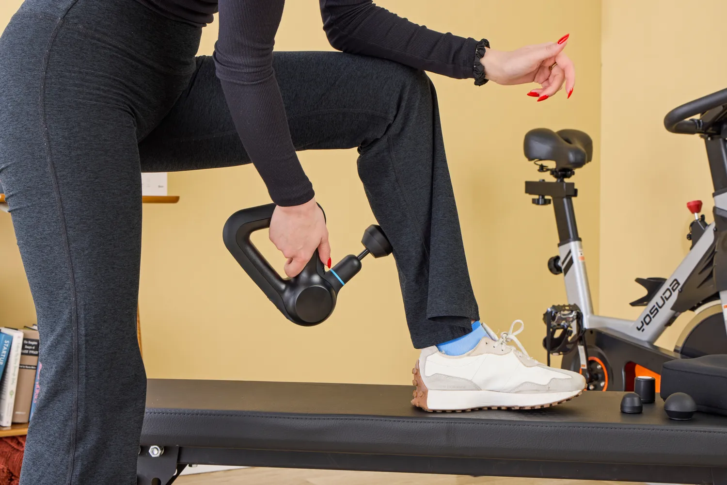 A person using the Theragun Prime on their back calf