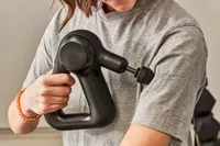 Person using Therabody Theragun Prime (4th Generation) on their upper arm