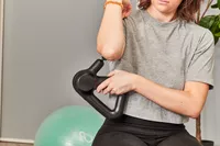 Person using Therabody Theragun Prime (4th Generation) on upper arm