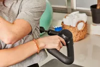 Person using Therabody Theragun Prime (4th Generation) on their back