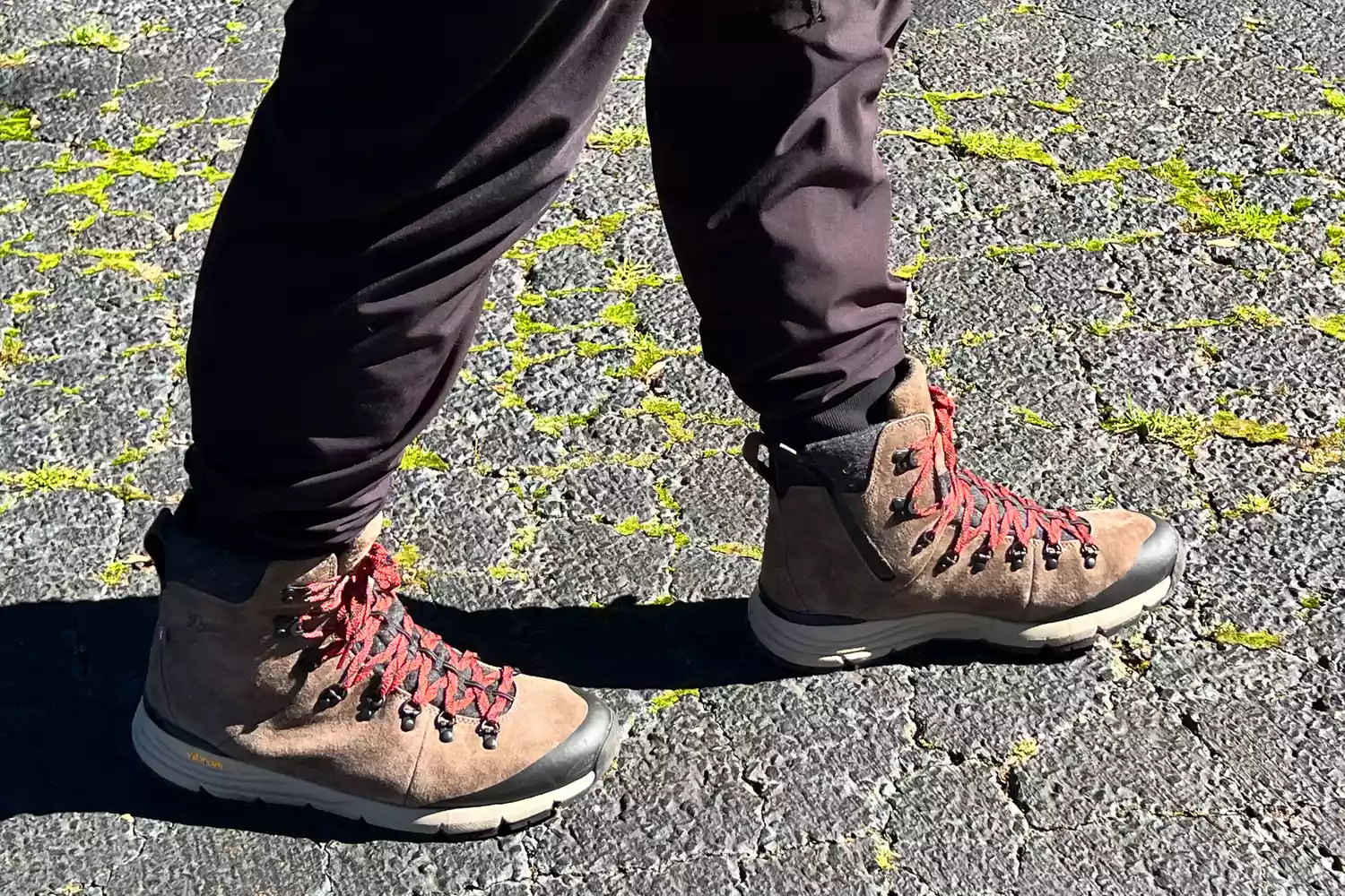 A person walks outside wearing the Danner Arctic 600 Side-Zip Boots