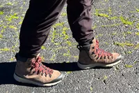 A person walks outside wearing the Danner Arctic 600 Side-Zip Boots
