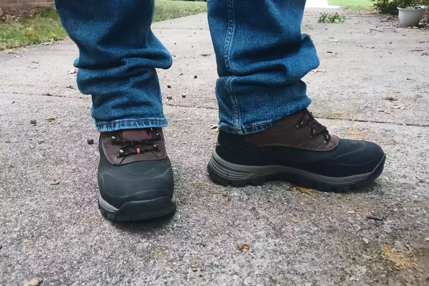 A person wears Nortive 8 Menâs Insulated Snow Boots outside