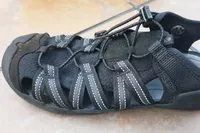A close up of the KEEN Men's H2 Water Sandal on tile floor