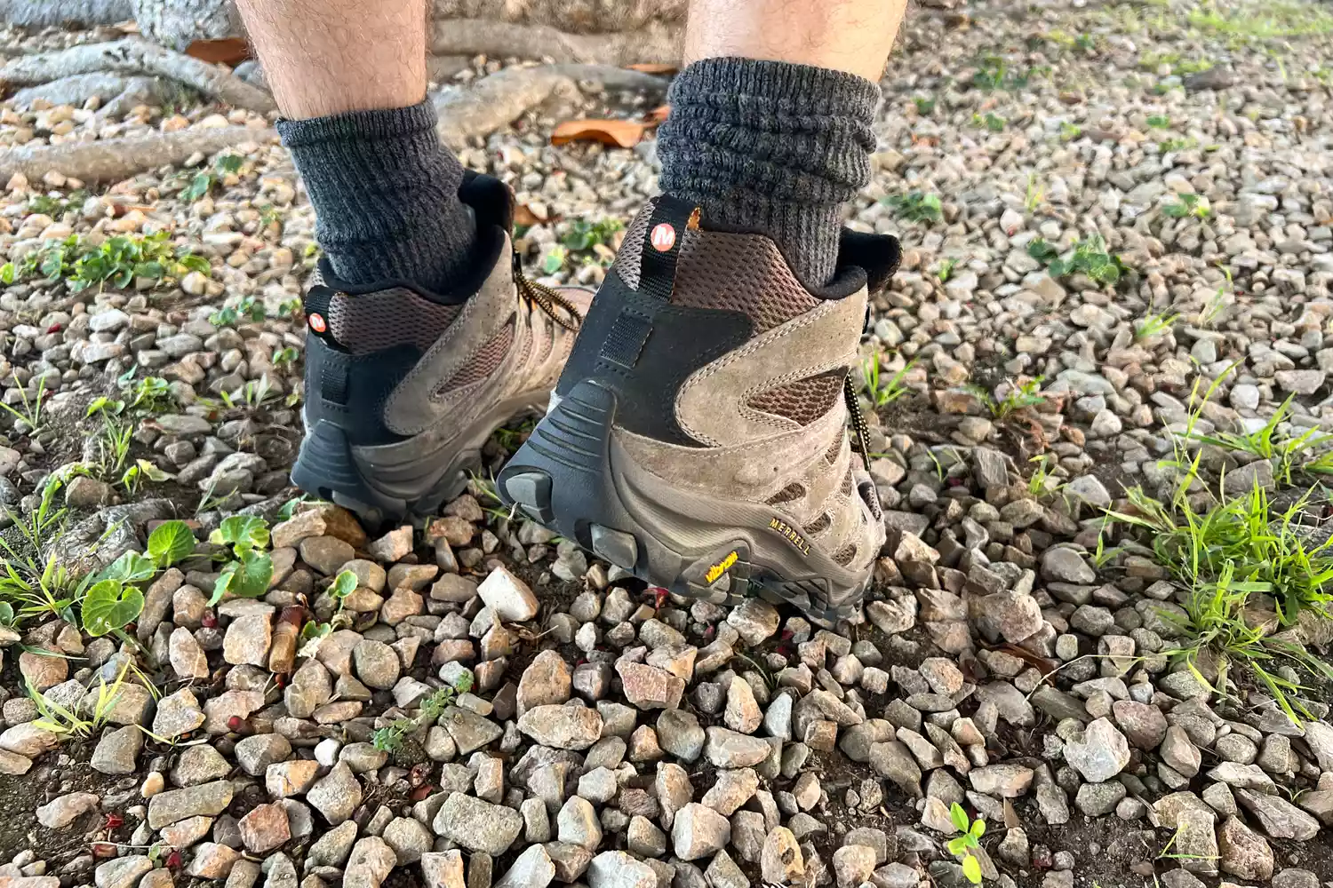 Person stepping on rocks wearing Merrell Moab 3 Mid Waterproof Hiking Boots