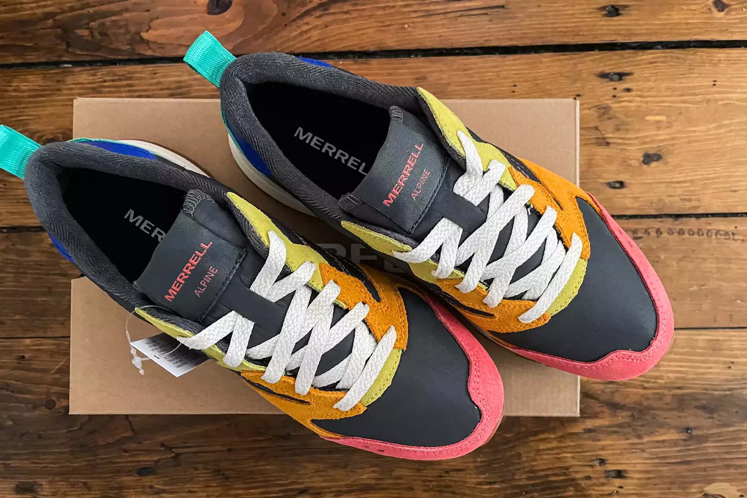 An overhead view of the Merrell Women's Alpine 83 Sneaker Sport sneakers posed on their box