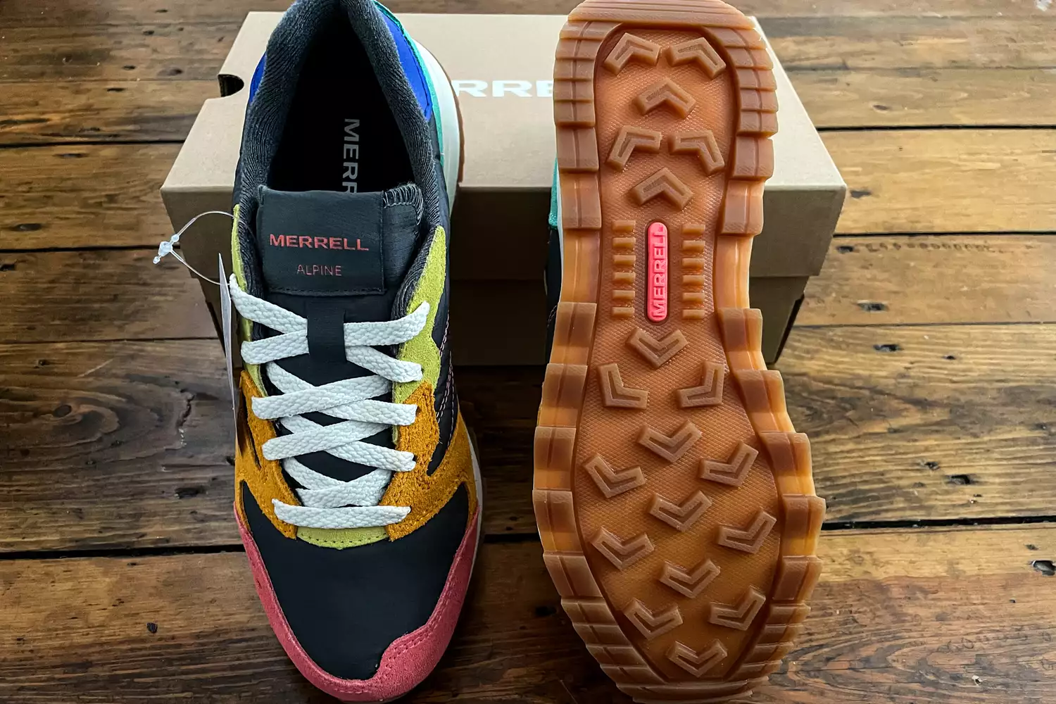 The Merrell Women's Alpine 83 Sneaker Sport sneakers posed on their box