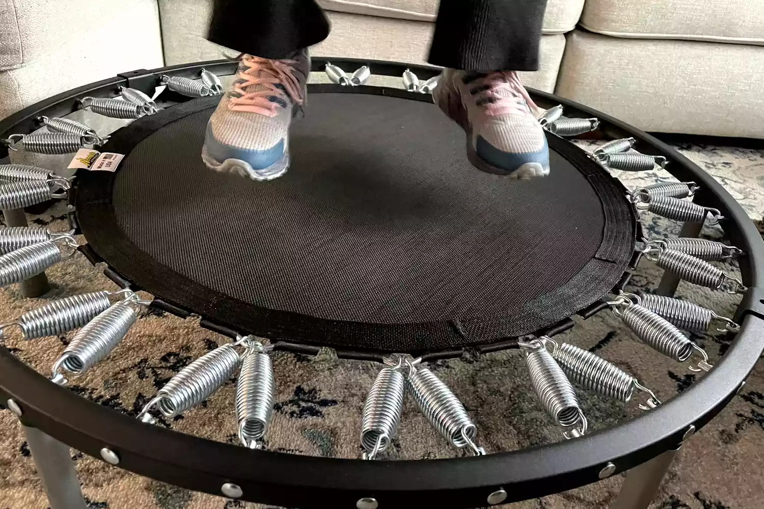 A person jumps on the Needak Soft-Bounce Folding Rebounder