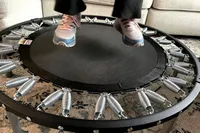 A person jumps on the Needak Soft-Bounce Folding Rebounder