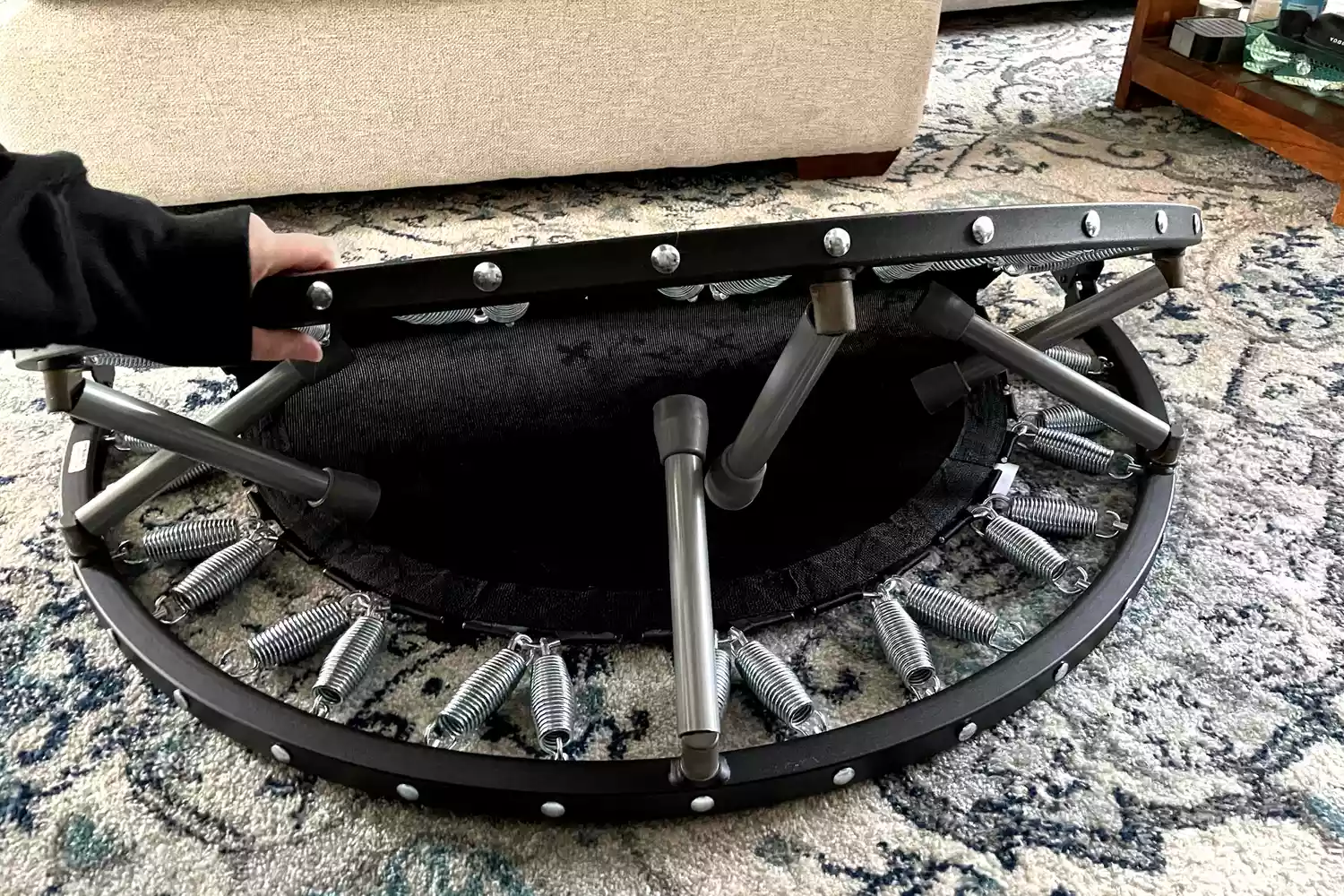 A person slowly folds up the Needak Soft-Bounce Folding Rebounder