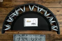 The Needak Soft-Bounce Folding Rebounder folded in half with the user manual on top