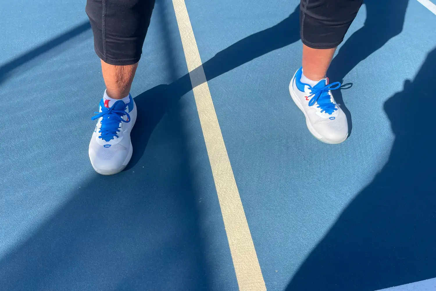 A person wears the New Balance Women's FuelCell 996v6 Pickleball Shoes while playing pickleball