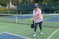 A person plays pickleball while wearing the New Balance Women's FuelCell 996v6 Pickleball Shoes