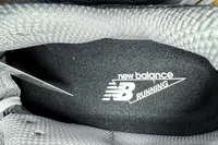 The brand name and logo printed on the inside of the New Balance Women's Made in USA 990v6 Sneakers
