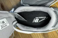 The brand name and logo printed on the sole of the New Balance Women's Made in USA 990v6 Sneakers