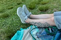 A person wears a pair of New Balance Men's 608v5 Cross Trainer Shoes