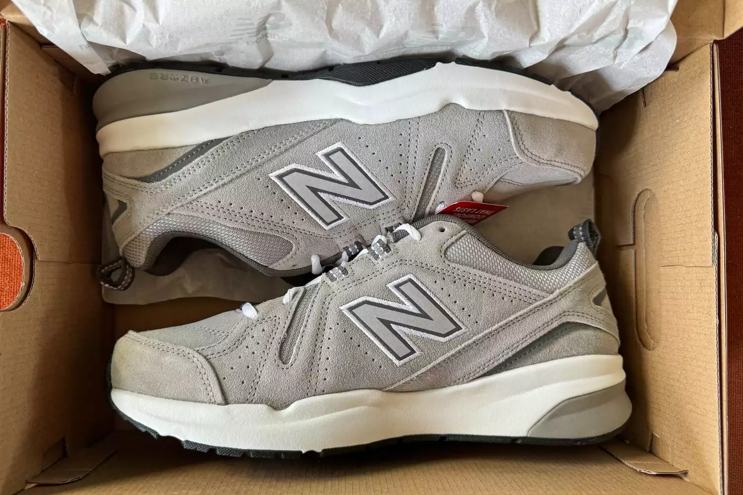 A pair of New Balance Men's 608v5 Cross Trainer Shoes inside a shoebox 