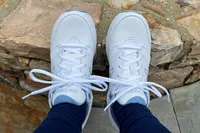 A person wears the New Balance Women’s 928v3 Walking Shoes outside 
