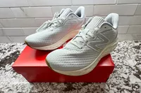 The New Balance Women's Fresh Foam Arishi v4 sneakers posed on top of their box