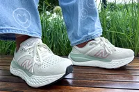A side view of a person wearing the New Balance Women's Made in USA Fresh Foam X 1540v4 Running Shoes