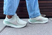 A side view of a person wearing the New Balance Women's Made in USA Fresh Foam X 1540v4 Running Shoes while she walks