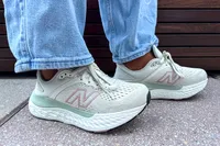 A side view of a person wearing the New Balance Women's Made in USA Fresh Foam X 1540v4 Running Shoes while walking outside
