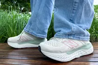 A person wears the New Balance Women's Made in USA Fresh Foam X 1540v4 Running Shoes while walking outside