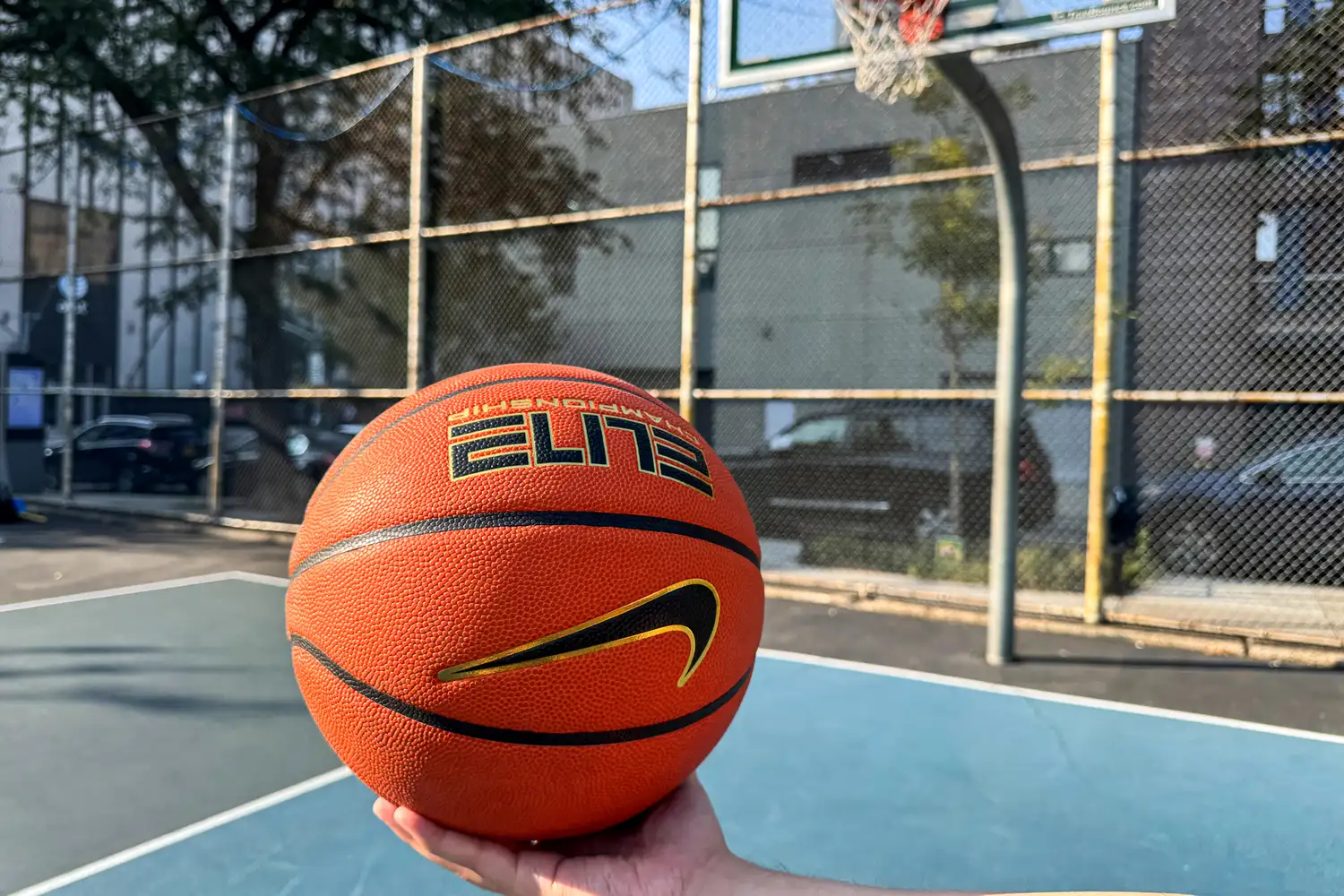 A person holds the Nike Elite Championship Basketball