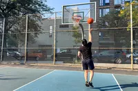 A person shoots the Nike Elite Championship Basketball