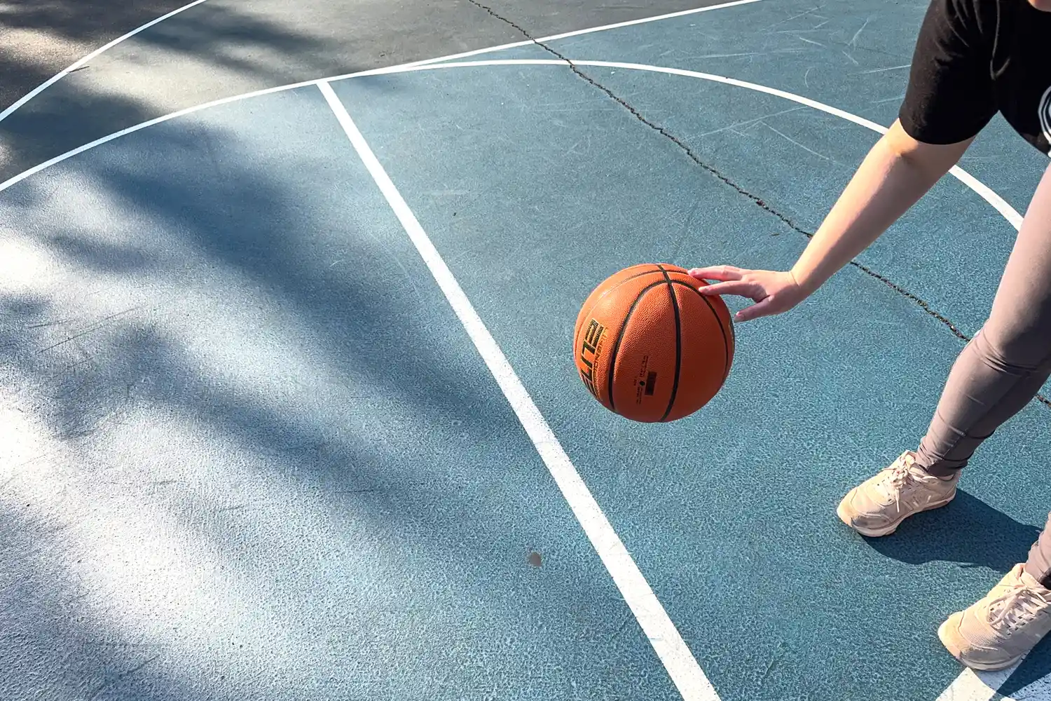 A person dribbles the Nike Elite Championship Basketball
