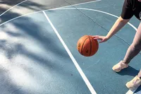A person dribbles the Nike Elite Championship Basketball