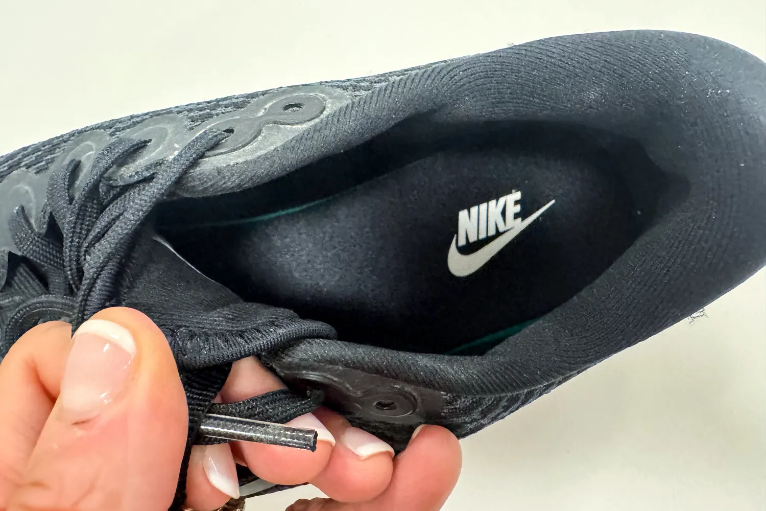 The brand name and logo printed on the sole of the Nike Motiva Women's Walking Shoes