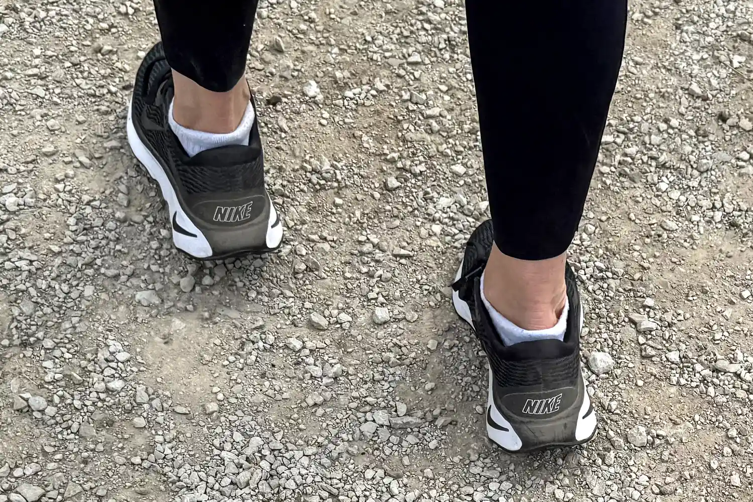 The back of a person wearing the Nike Motiva Women's Walking Shoes