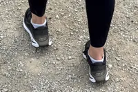 The back of a person wearing the Nike Motiva Women's Walking Shoes