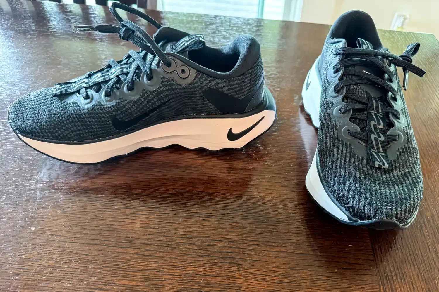 A pair of Nike Motiva Women's Walking Shoes on a table