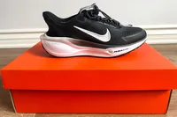 A side view of the Nike Pegasus EasyOn Women's Road Running Shoe on a shoebox