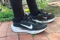 A person walks outside while wearing the Nike Pegasus EasyOn Women's Road Running Shoes