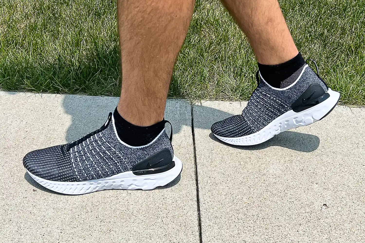 A person walks outside while wearing the Nike React Phantom Run 2 Men's Road Running Shoes