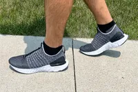 A person walks outside while wearing the Nike React Phantom Run 2 Men's Road Running Shoes
