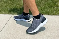A person walks outside while wearing the Nike React Phantom Run 2 Men's Road Running Shoes