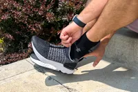 A person places the Nike React Phantom Run 2 Men's Road Running Shoe on their foot