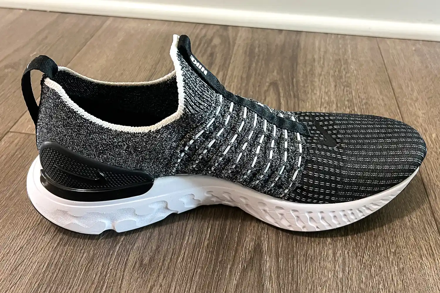 The Nike React Phantom Run 2 Men's Road Running Shoe on a wooden floor