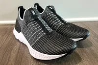 A pair of Nike React Phantom Run 2 Men's Road Running Shoes on a wooden floor