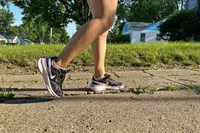 A person walks outside while wearing a pair of Nike Structure 25 Women's Road Running Shoes