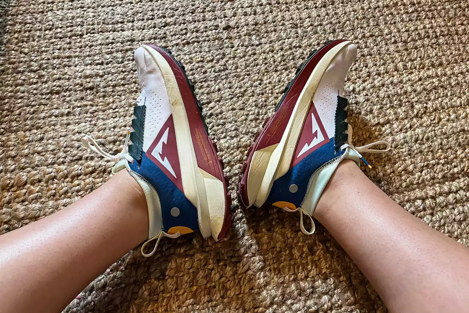 A person wears the Nike Zegama 2 Women's Trail Running Shoes while stretching