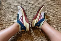 A person wears the Nike Zegama 2 Women's Trail Running Shoes while stretching